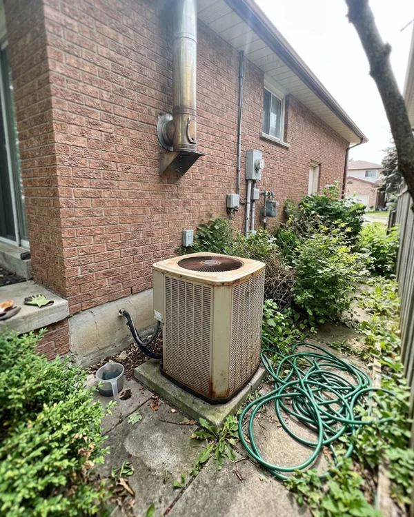 20-year-old furnace and AC condenser before the retrofit