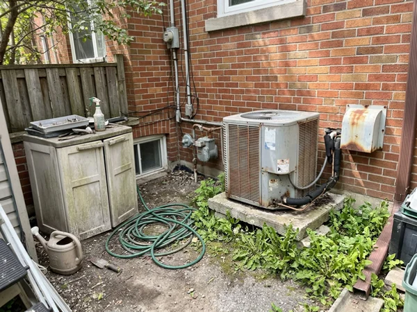 Before: dead AC condenser beside a Leaside home