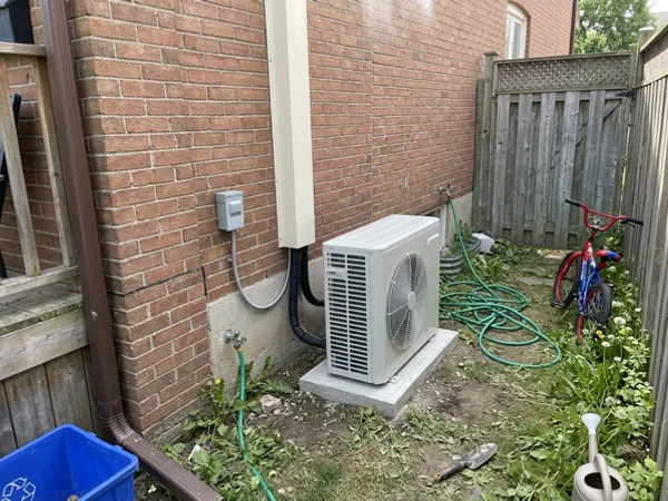 Daikin Fit 2.5-ton heat pump in the old AC spot beside a Leslieville semi