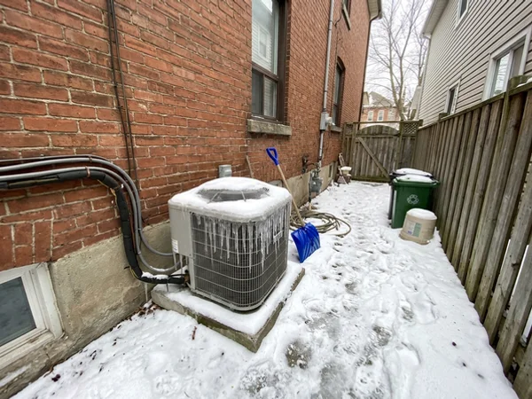 Daikin outdoor coil encased in ice before a defrost repair in Little Italy