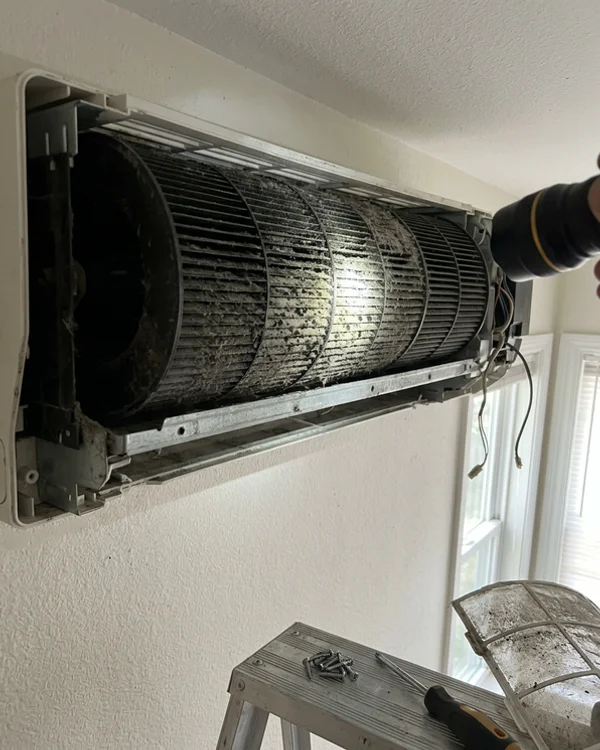 Dirty ductless blower wheel with buildup before cleaning