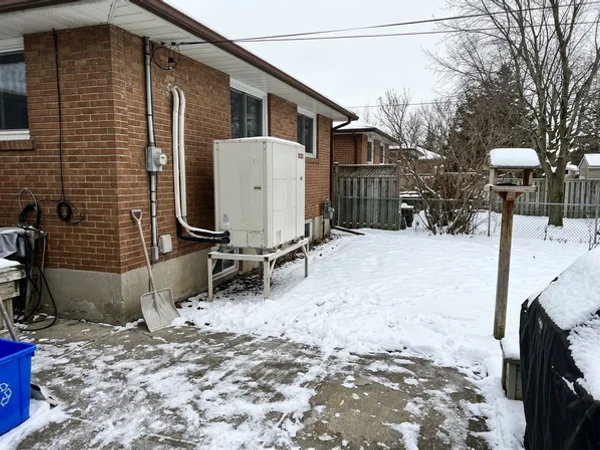 Fujitsu multi-zone outdoor unit behind a Scarborough Village bungalow