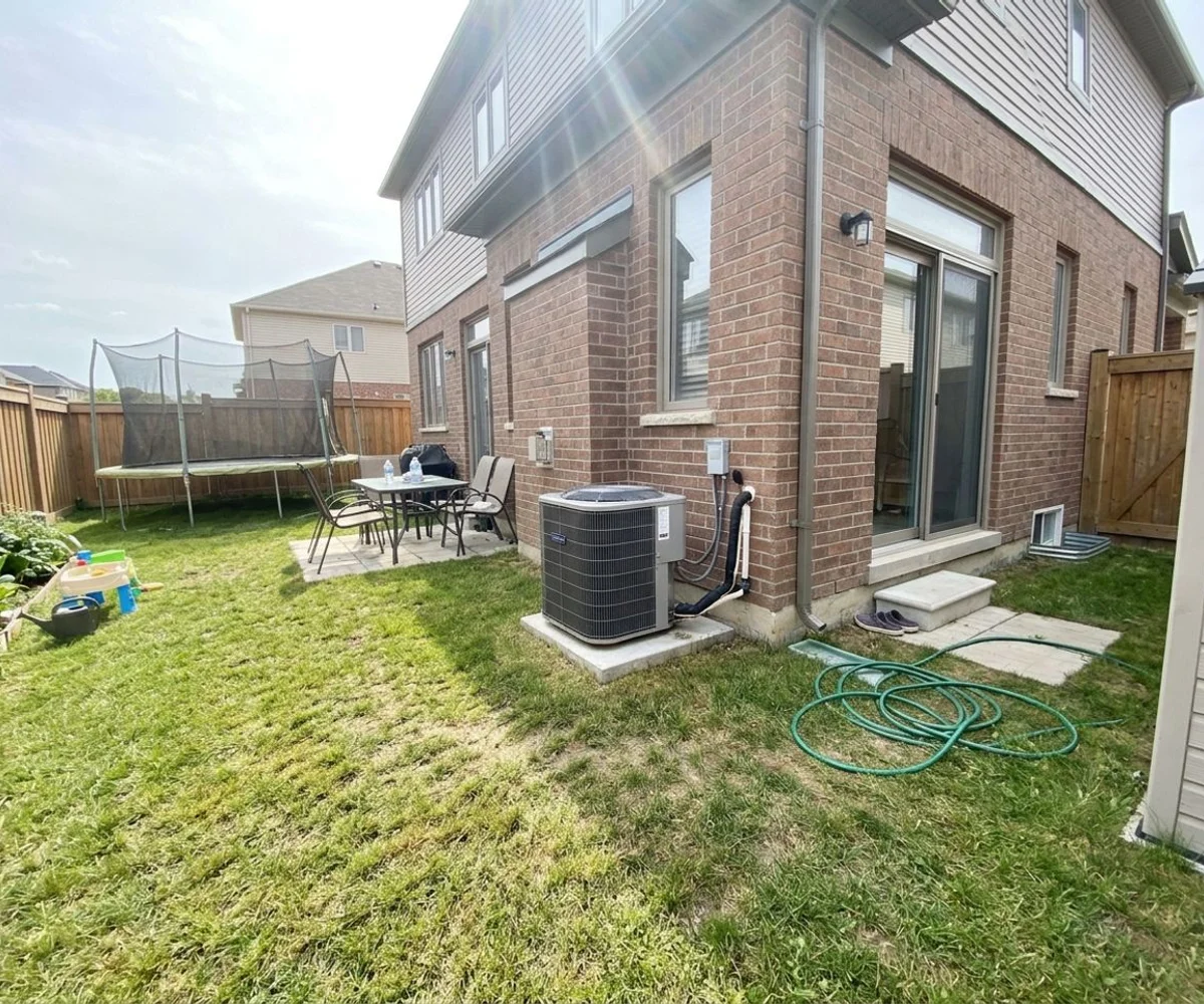 Gree Flexx outdoor unit beside a newer Heart Lake detached house