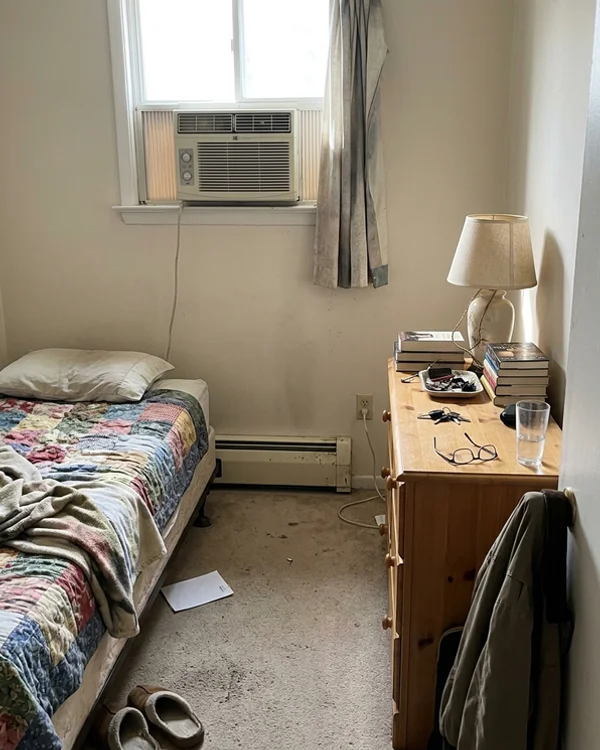 Electric baseboard and window AC in a bungalow bedroom before the ductless retrofit