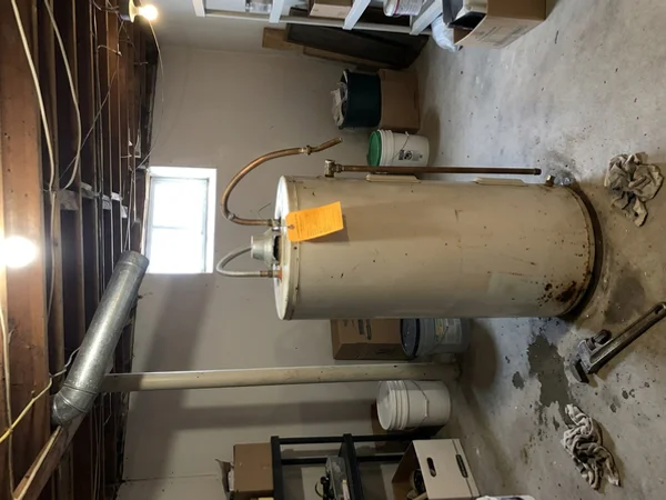Old rented gas water heater tank tagged for return