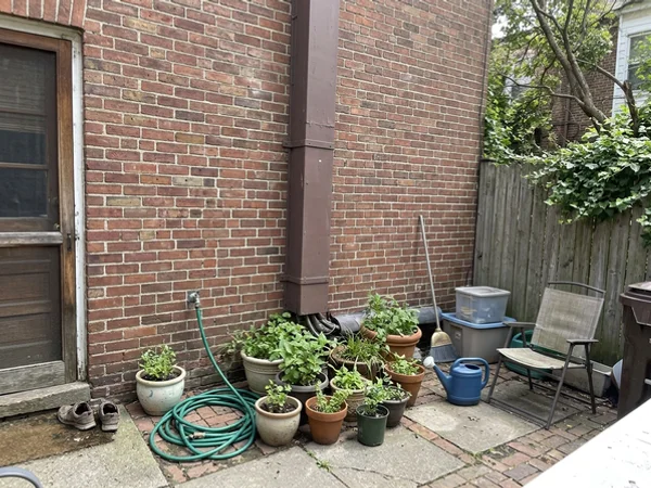 Three Mitsubishi line sets in exterior line hide on a Cabbagetown row house