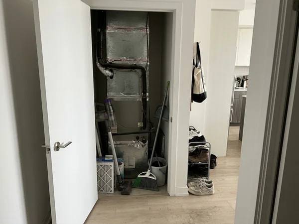 VTAC vertical heat pump in a King West condo utility closet